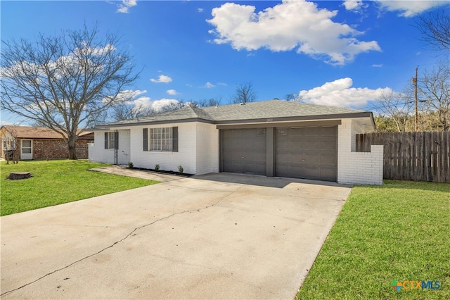 ranch-style home with a garage and a front lawn