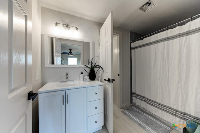 bathroom with a shower with curtain, ceiling fan, and vanity