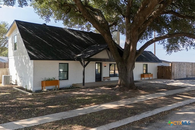 view of front of house featuring a porch and cooling unit