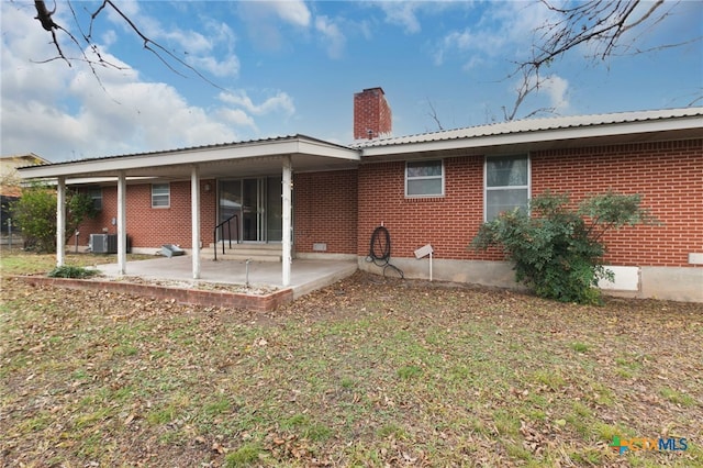 rear view of property with central AC and a patio area