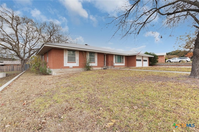 ranch-style home with a front yard and a garage