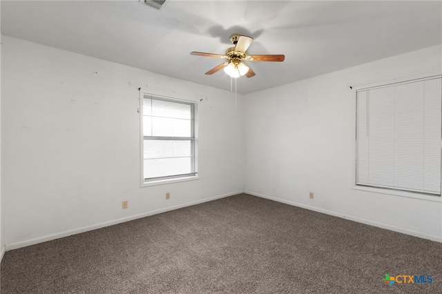 carpeted spare room with ceiling fan