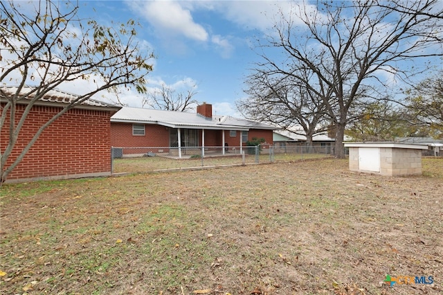 rear view of property with a lawn