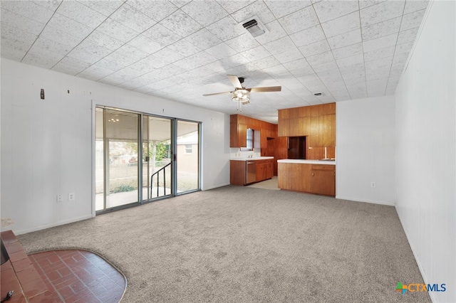 living room featuring ceiling fan, wooden walls, and carpet floors