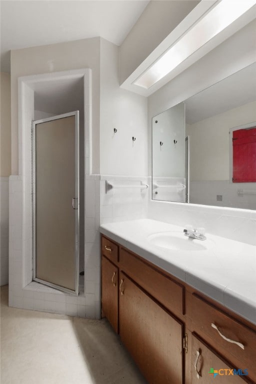 bathroom with vanity and an enclosed shower