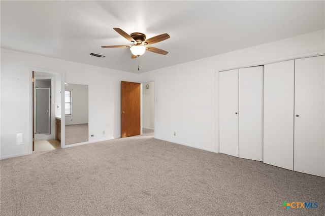 unfurnished bedroom with ceiling fan, a closet, and light colored carpet