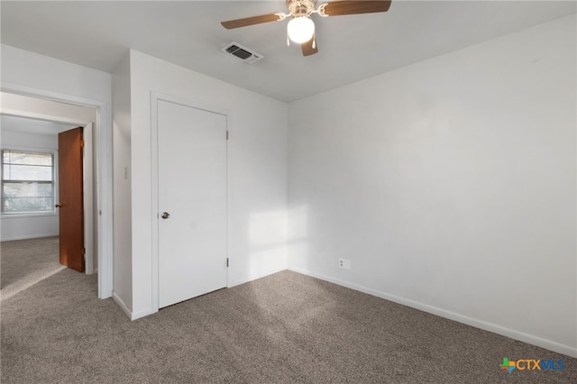 unfurnished bedroom with ceiling fan and carpet