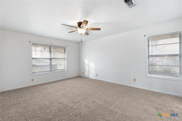 spare room with ceiling fan, carpet, and a healthy amount of sunlight