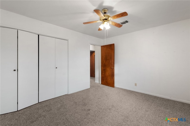 unfurnished bedroom featuring ceiling fan, a closet, and light colored carpet