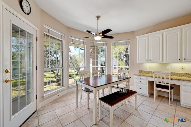 1100 Appalachian Trl, San Marcos, TX 78666 - dining area featuring built in desk, a ceiling fan, and light tile patterned floors