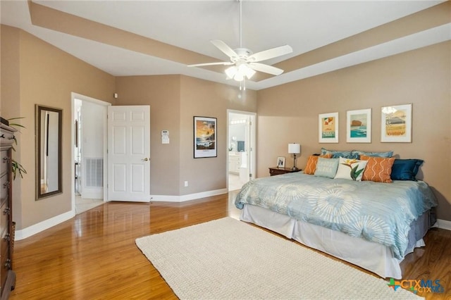1100 Appalachian Trl, San Marcos, TX 78666 - bedroom featuring wood finished floors, visible vents, baseboards, and connected bathroom