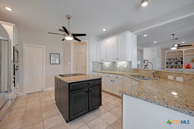 1100 Appalachian Trl, San Marcos, TX 78666 - kitchen with decorative backsplash, a ceiling fan, a sink, and white cabinetry