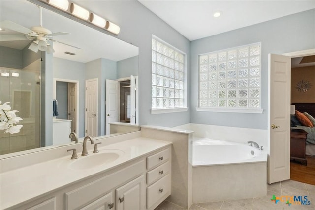 1100 Appalachian Trl, San Marcos, TX 78666 - ensuite bathroom featuring a shower stall, tile patterned floors, a ceiling fan, vanity, and a garden tub