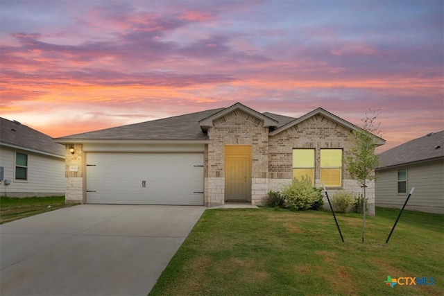 view of front of property featuring a garage and a yard