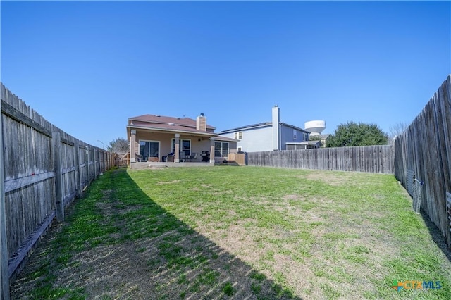 view of yard featuring a patio area and a fenced backyard