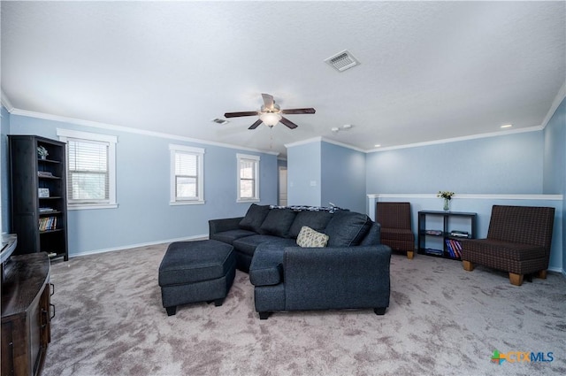 living area featuring carpet floors, visible vents, crown molding, and baseboards