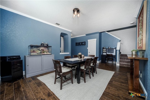 dining room with visible vents, crown molding, stairway, and wood finished floors