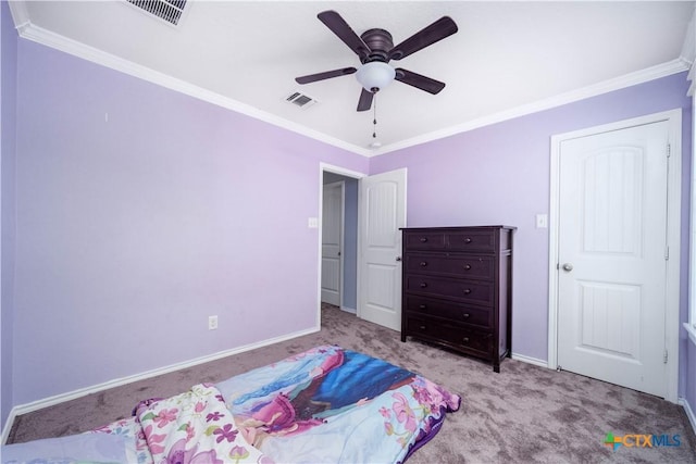 bedroom with crown molding, visible vents, and carpet flooring