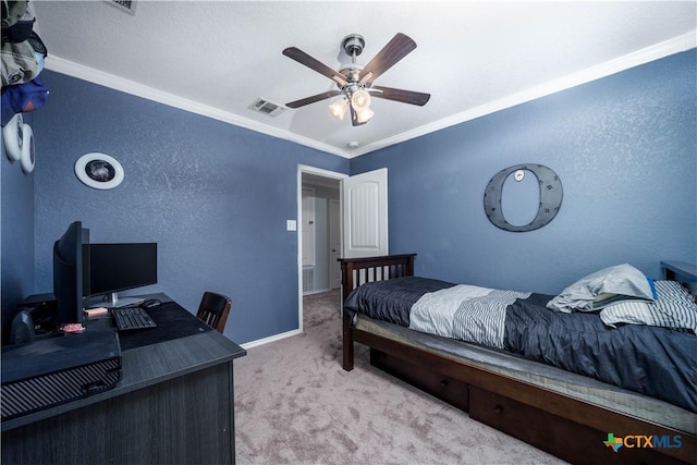 carpeted bedroom with ceiling fan, a textured wall, visible vents, baseboards, and crown molding