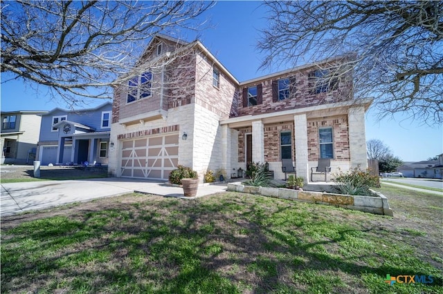 traditional-style house with driveway, brick siding, a garage, and a front yard