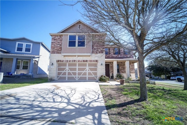 traditional-style home featuring a garage, driveway, and a front lawn