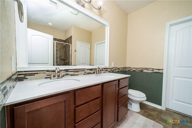 full bathroom featuring a stall shower, visible vents, a sink, and double vanity