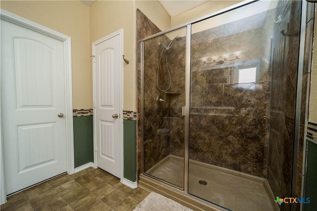 full bath featuring a shower stall