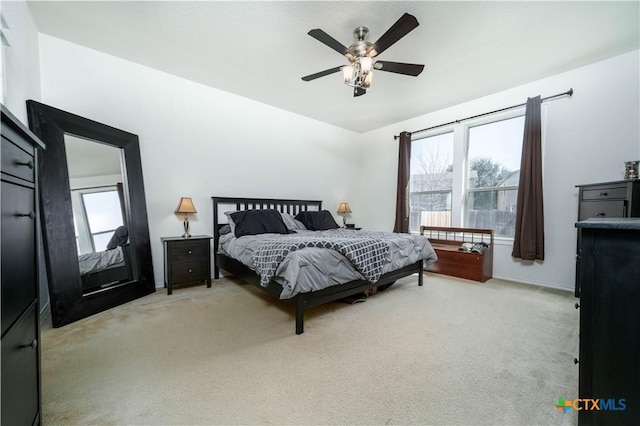 bedroom featuring carpet floors, multiple windows, and ceiling fan