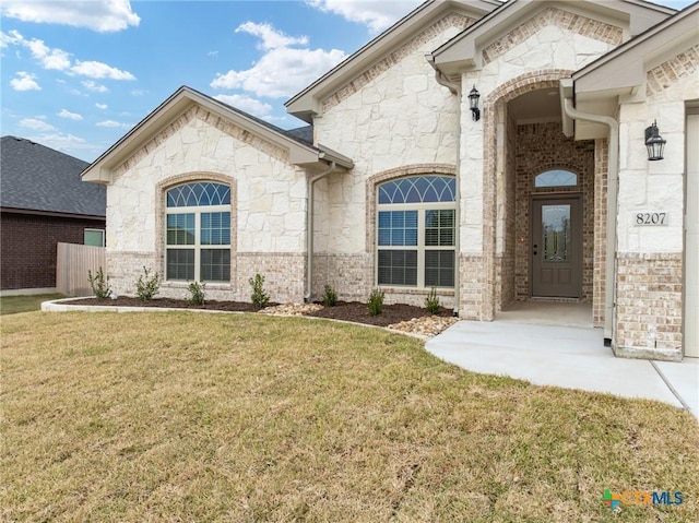 entrance to property featuring a yard