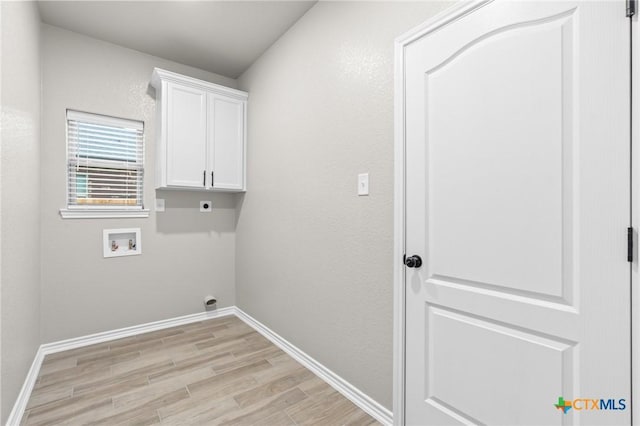 laundry area featuring hookup for a washing machine, hookup for an electric dryer, cabinets, and light hardwood / wood-style floors