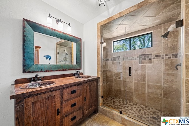 bathroom featuring vanity and a shower with door