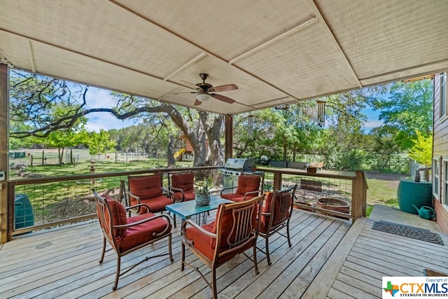 wooden deck with ceiling fan, an outdoor living space with a fire pit, and grilling area