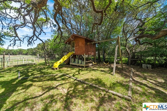 view of jungle gym featuring a lawn