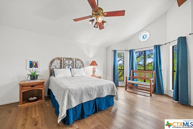 bedroom with wood-type flooring, ceiling fan, and lofted ceiling