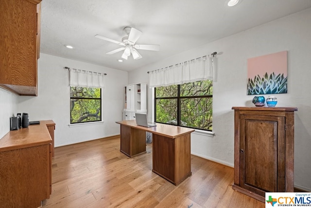 office area with ceiling fan and light hardwood / wood-style flooring