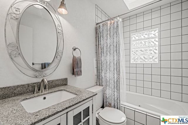 full bathroom with vanity, shower / bath combo, and toilet