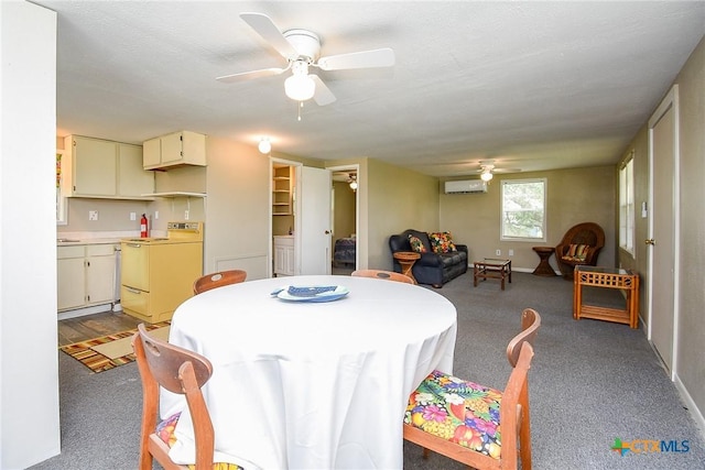 1551 Bayview Dr, Palacios, TX 77465 - dining room featuring carpet floors, ceiling fan, baseboards, and an AC wall unit