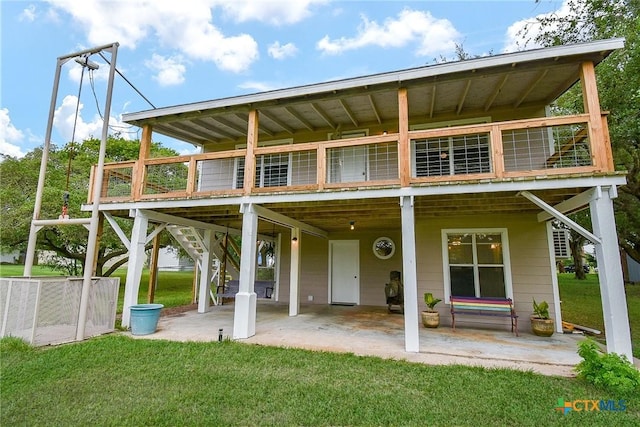 1551 Bayview Dr, Palacios, TX 77465 - back of house featuring a lawn, a deck, stairs, and a patio area