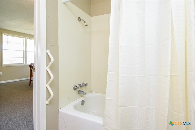 1551 Bayview Dr, Palacios, TX 77465 - full bath featuring baseboards and shower / bath combination with curtain