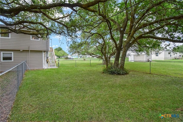 1551 Bayview Dr, Palacios, TX 77465 - view of yard featuring stairway and a fenced backyard
