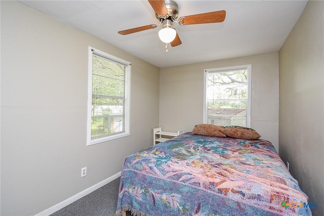 1551 Bayview Dr, Palacios, TX 77465 - bedroom with carpet floors, multiple windows, baseboards, and ceiling fan