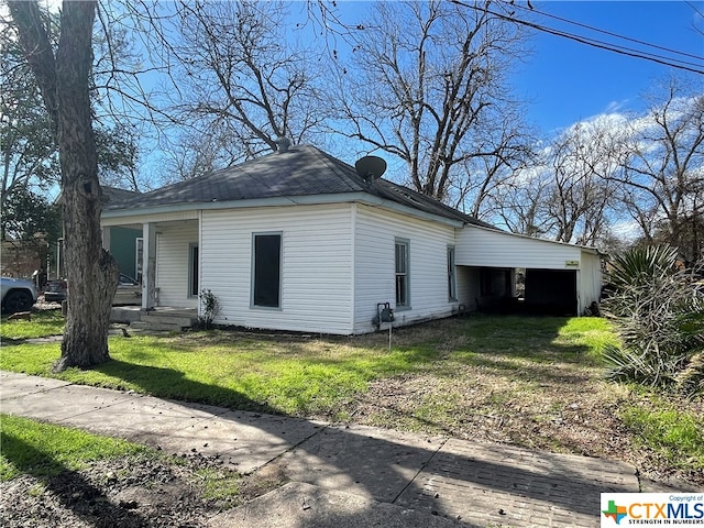 view of side of home featuring a yard