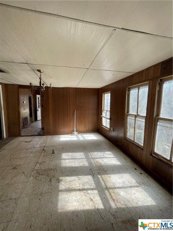 empty room featuring wooden walls