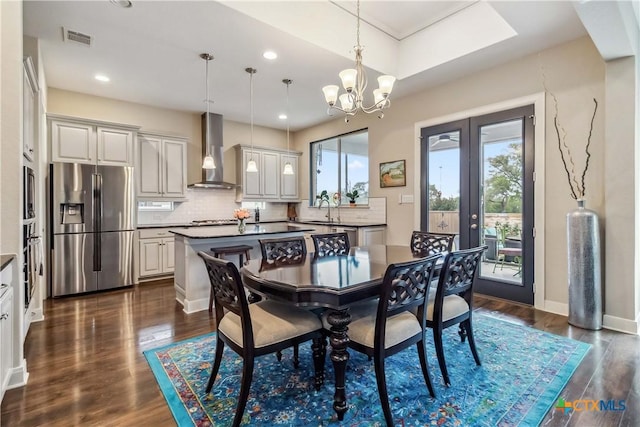 1404 Andalucia Dr, San Marcos, TX 78666 - dining room featuring a chandelier, dark wood-type flooring, recessed lighting, french doors, and baseboards