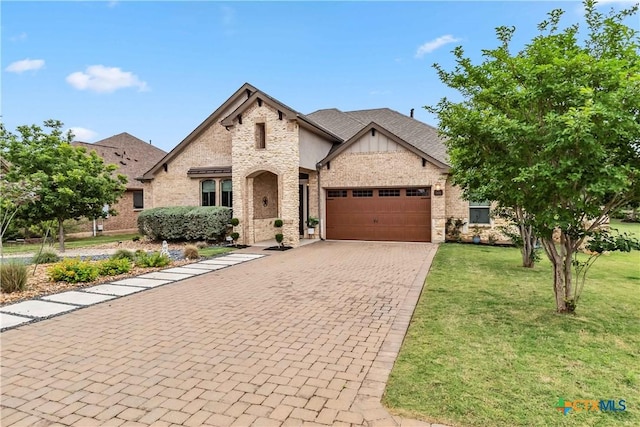 1404 Andalucia Dr, San Marcos, TX 78666 - french provincial home with an attached garage, a front yard, driveway, and brick siding