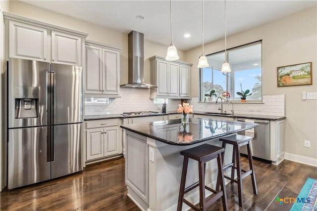 1404 Andalucia Dr, San Marcos, TX 78666 - kitchen with appliances with stainless steel finishes, wall chimney exhaust hood, dark countertops, a sink, and recessed lighting