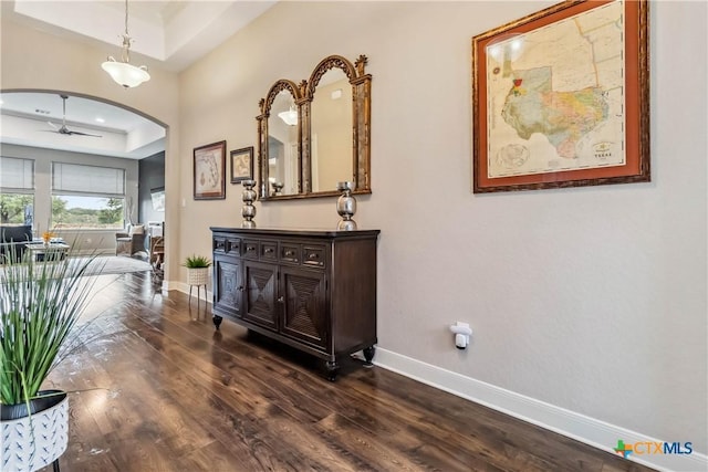 1404 Andalucia Dr, San Marcos, TX 78666 - corridor featuring a tray ceiling, dark wood-style floors, and baseboards