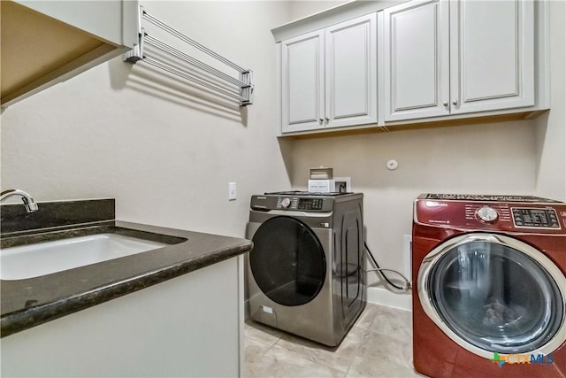 1404 Andalucia Dr, San Marcos, TX 78666 - washroom featuring washer and dryer, cabinet space, and light tile patterned flooring
