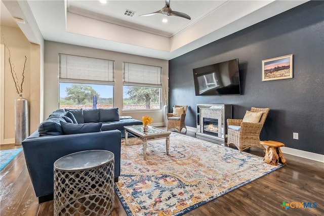 1404 Andalucia Dr, San Marcos, TX 78666 - living area with wood finished floors, ceiling fan, baseboards, crown molding, and a glass covered fireplace