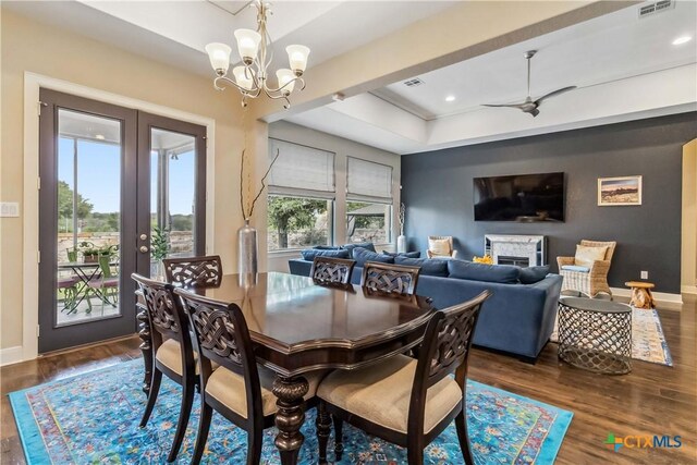 1404 Andalucia Dr, San Marcos, TX 78666 - dining area featuring dark wood-style floors, a raised ceiling, baseboards, french doors, and a chandelier